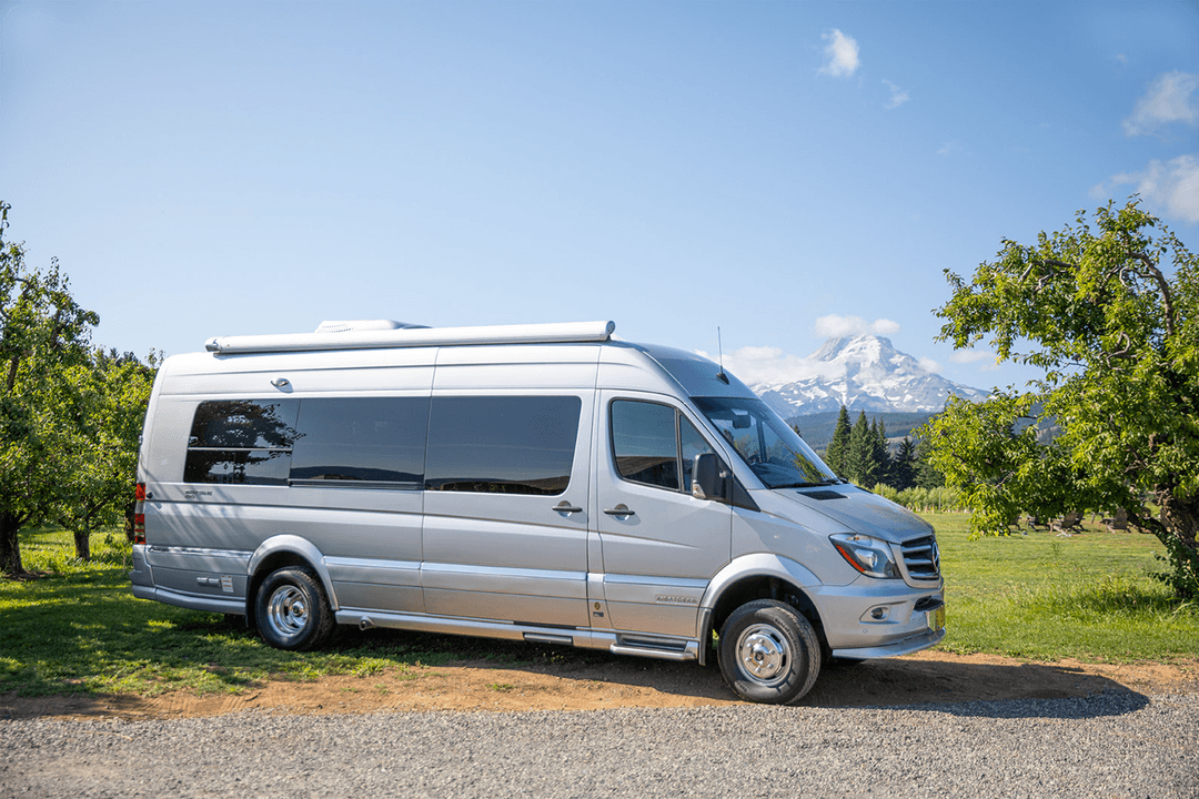 Photo of an amenage van parked in front of a mountain